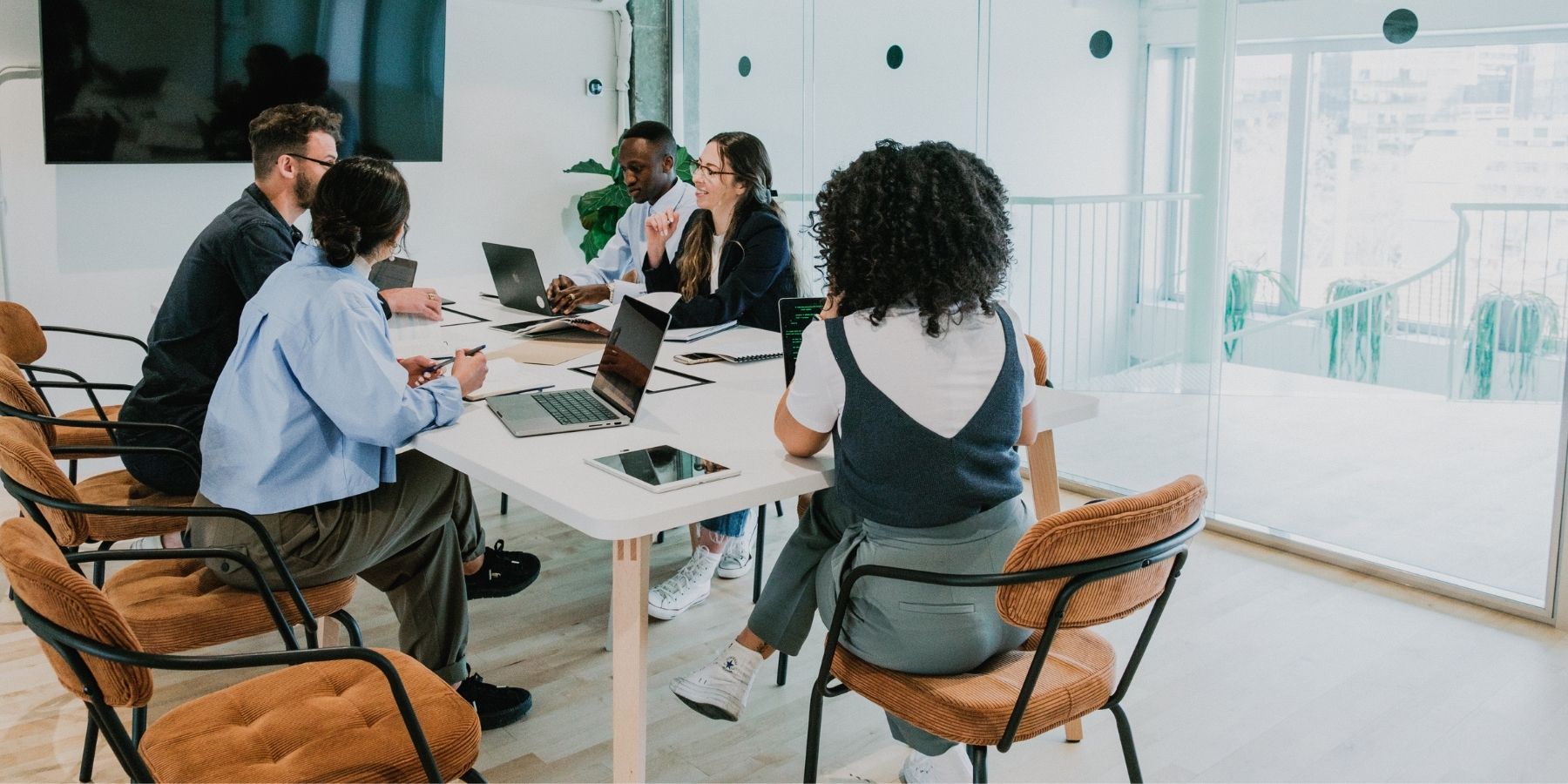 Team collaborating at table in 2025, thriving in future-proof careers safe from AI