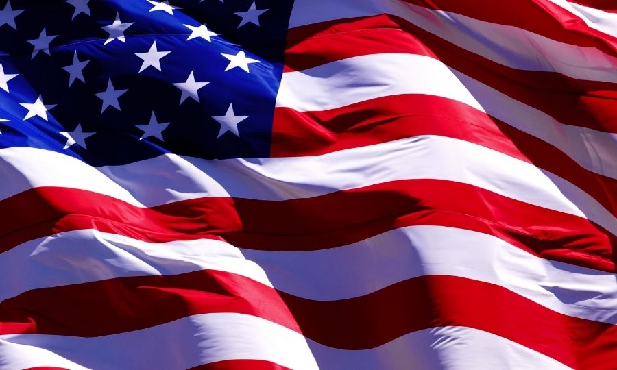 A close-up of the American flag waving, symbolizing national regulations and compliance.