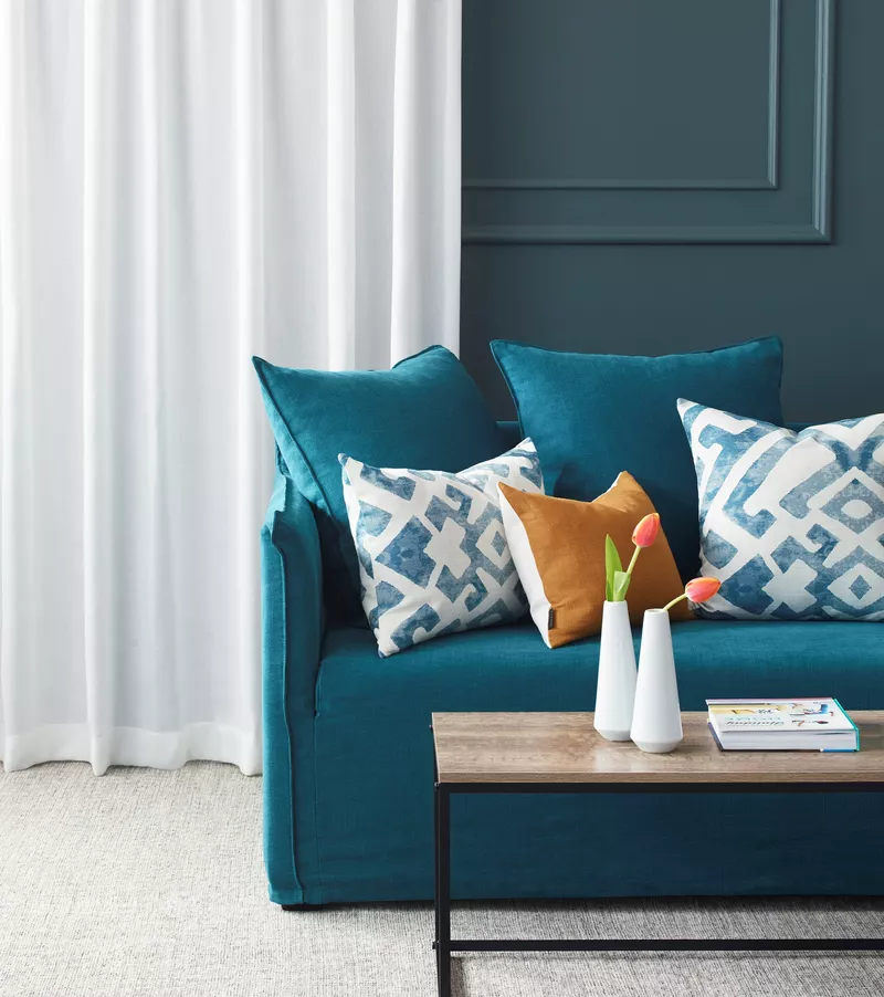 Blue sofa and white curtains