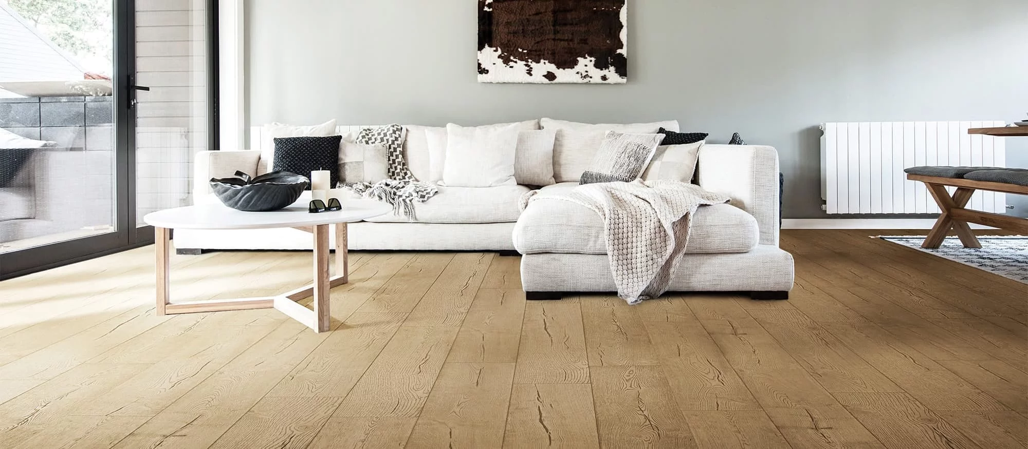 Living room with white sofa and with wood hard flooring