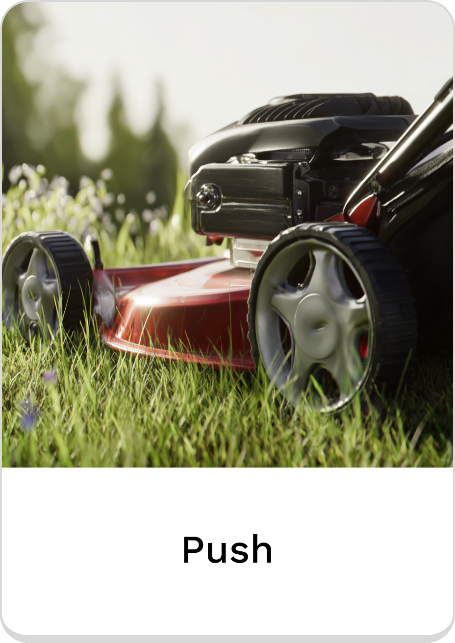 Close-up of a push lawn mower on fresh green grass.