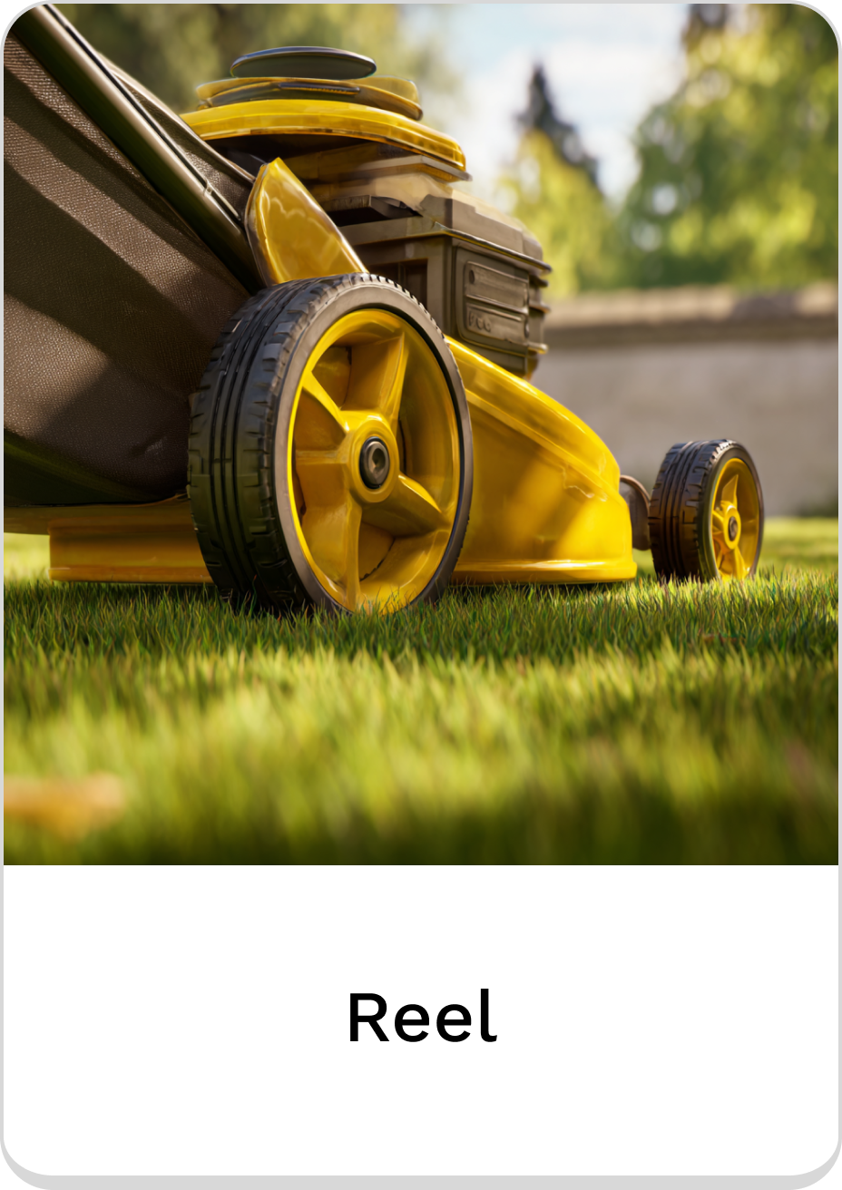 Bright yellow reel lawn mower on lush green grass.