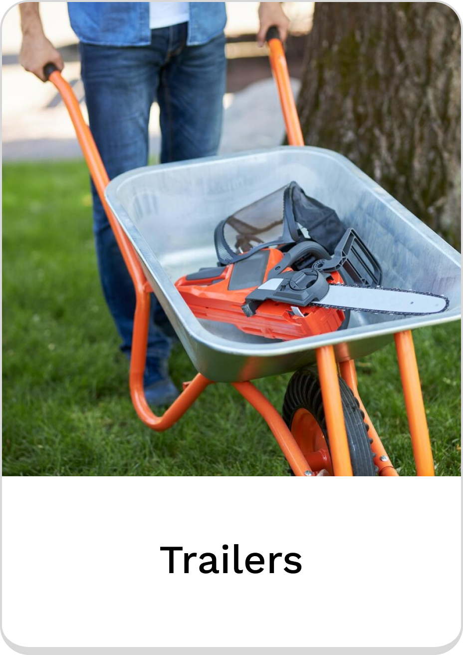 Person using a wheelbarrow for easy transport of tools in trailers.