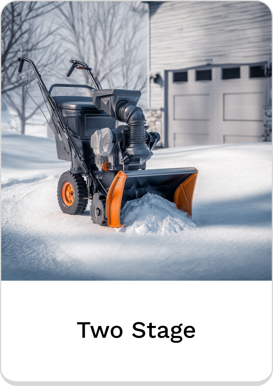 Efficient two-stage snow blower clearing snowy driveway in winter landscape.
