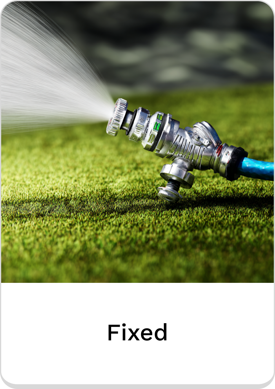 Fixed garden sprinkler nozzle spraying water on lush green grass.