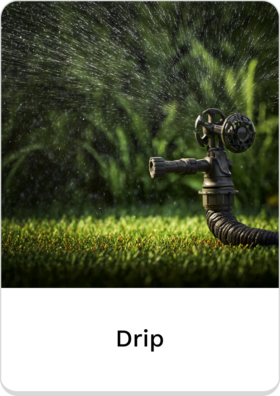 High-efficiency drip irrigation system spraying water on lush green grass.