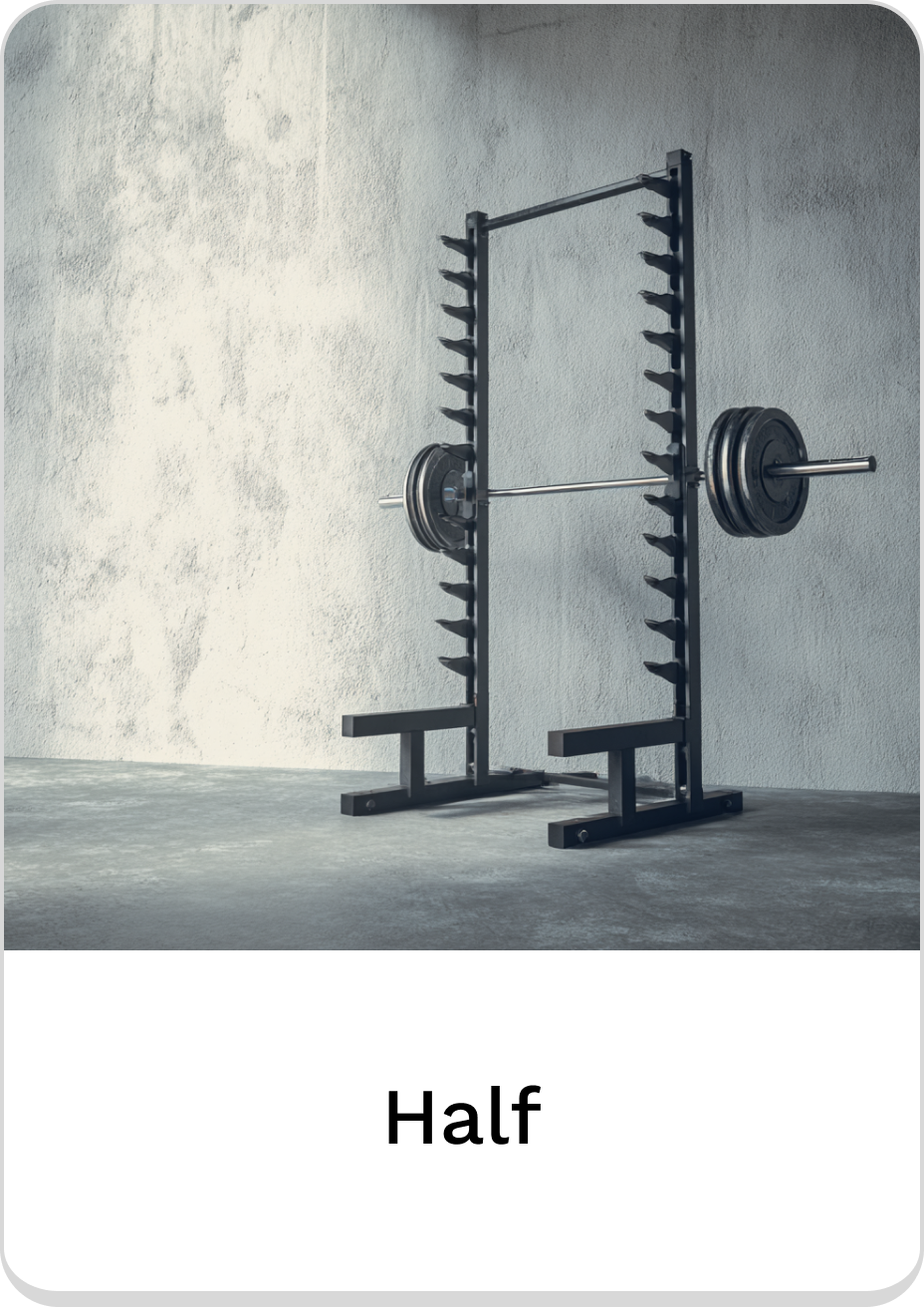 Half rack for strength training with weights in a modern gym setting.