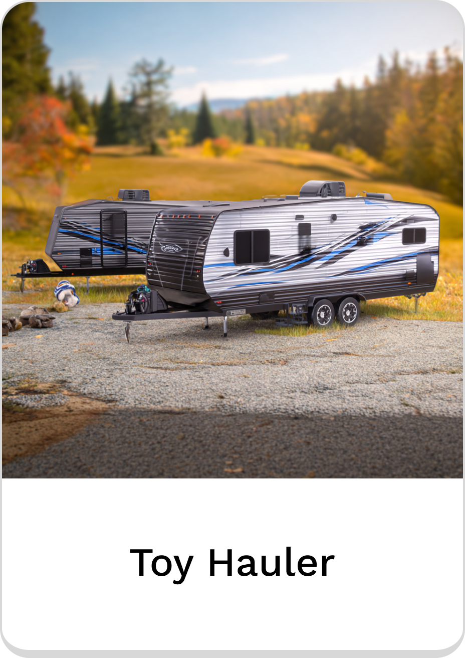 Stylish toy hauler camping trailer in an outdoor setting, perfect for adventures.
