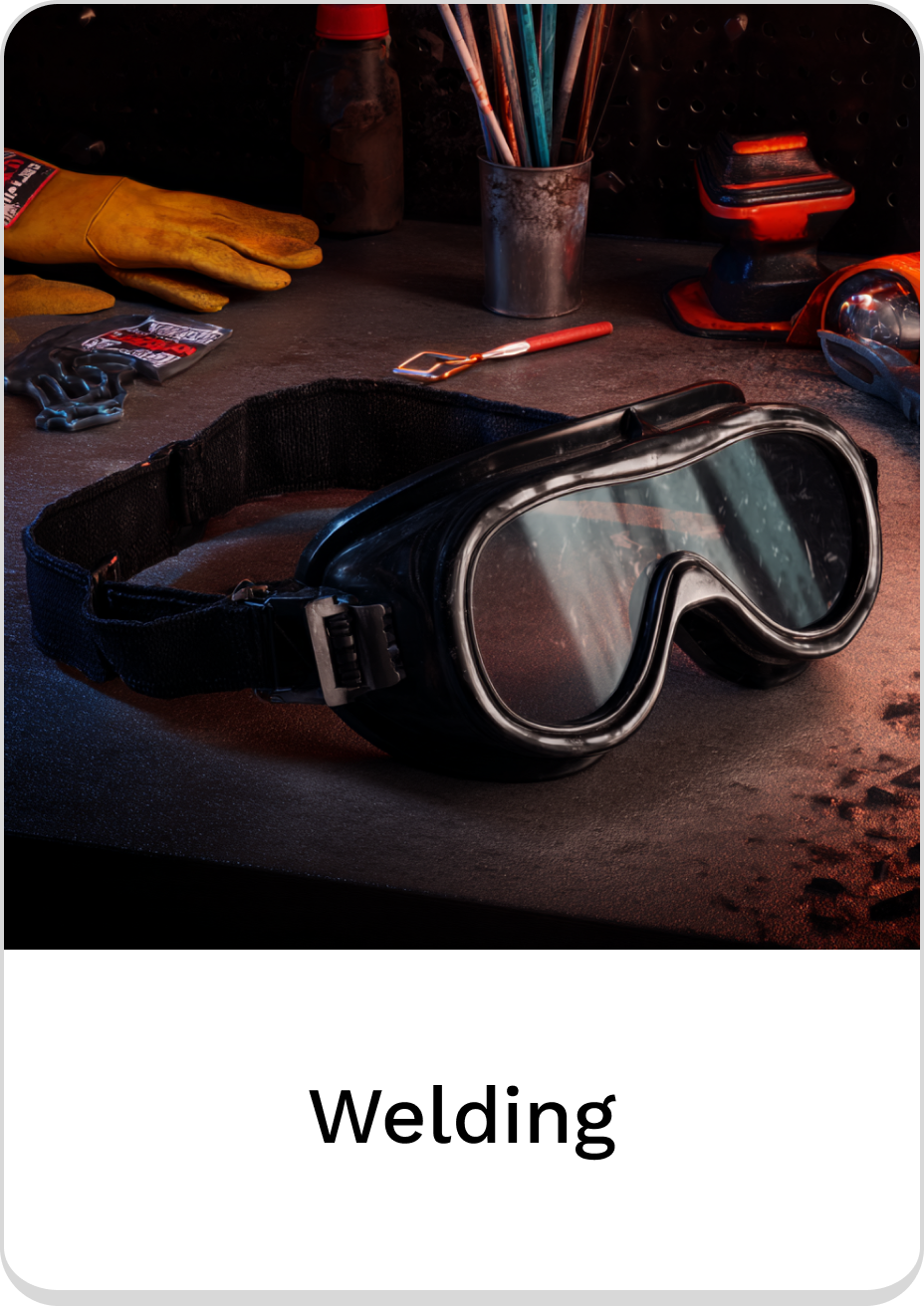 Welding goggles on a workbench with tools and supplies for safety.