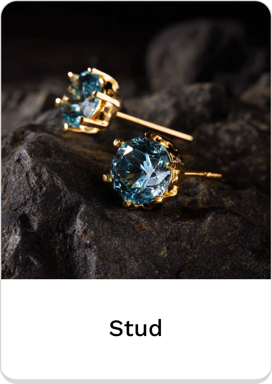 Elegant blue crystal stud earrings with gold settings on a dark stone background.
