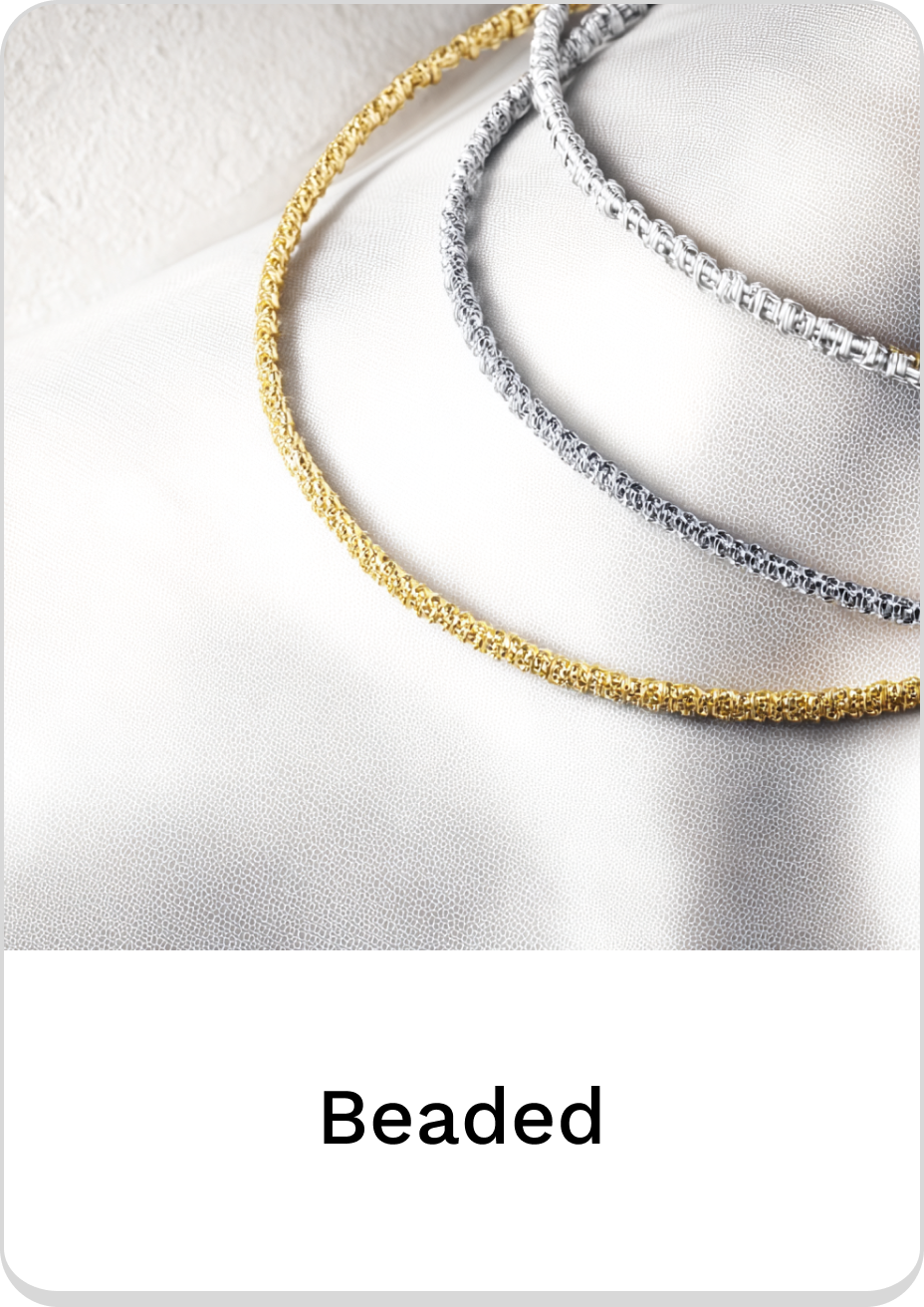 Elegant beaded necklaces in gold, silver, and gray on textured surface.