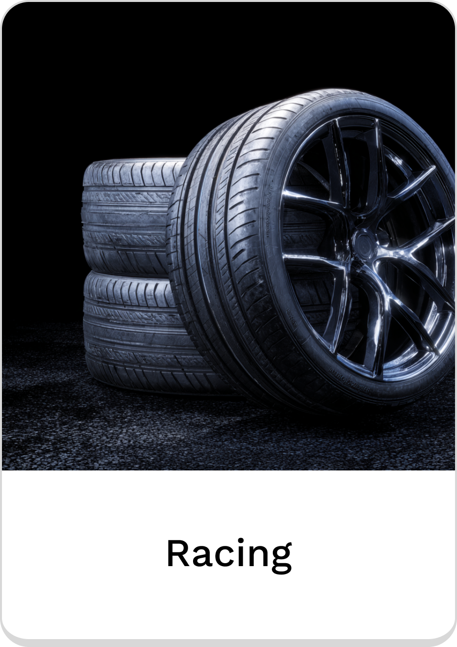 High-performance racing tires stacked against a dark background for motorsport enthusiasts.
