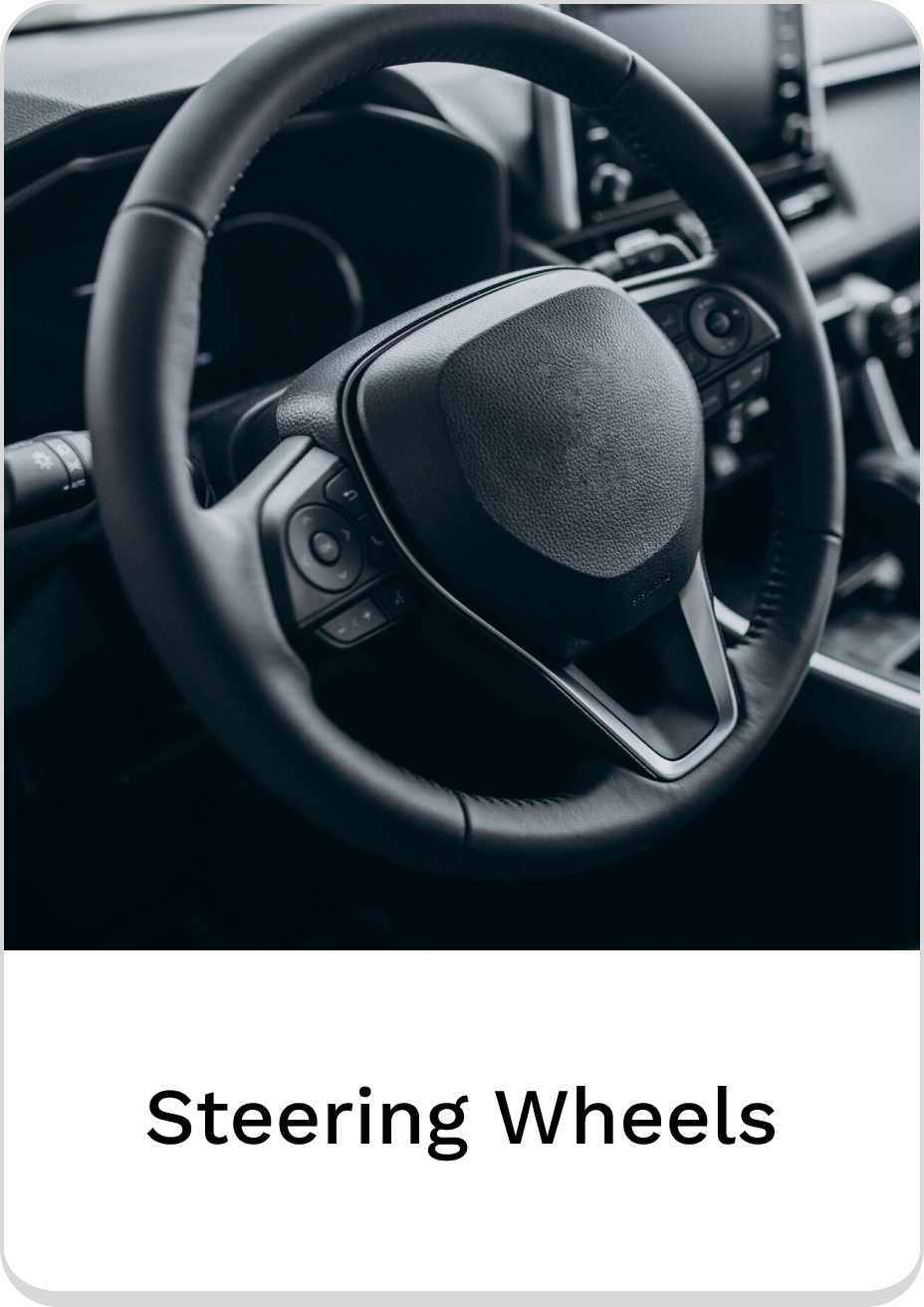 Close-up of a modern steering wheel in a sleek car interior.