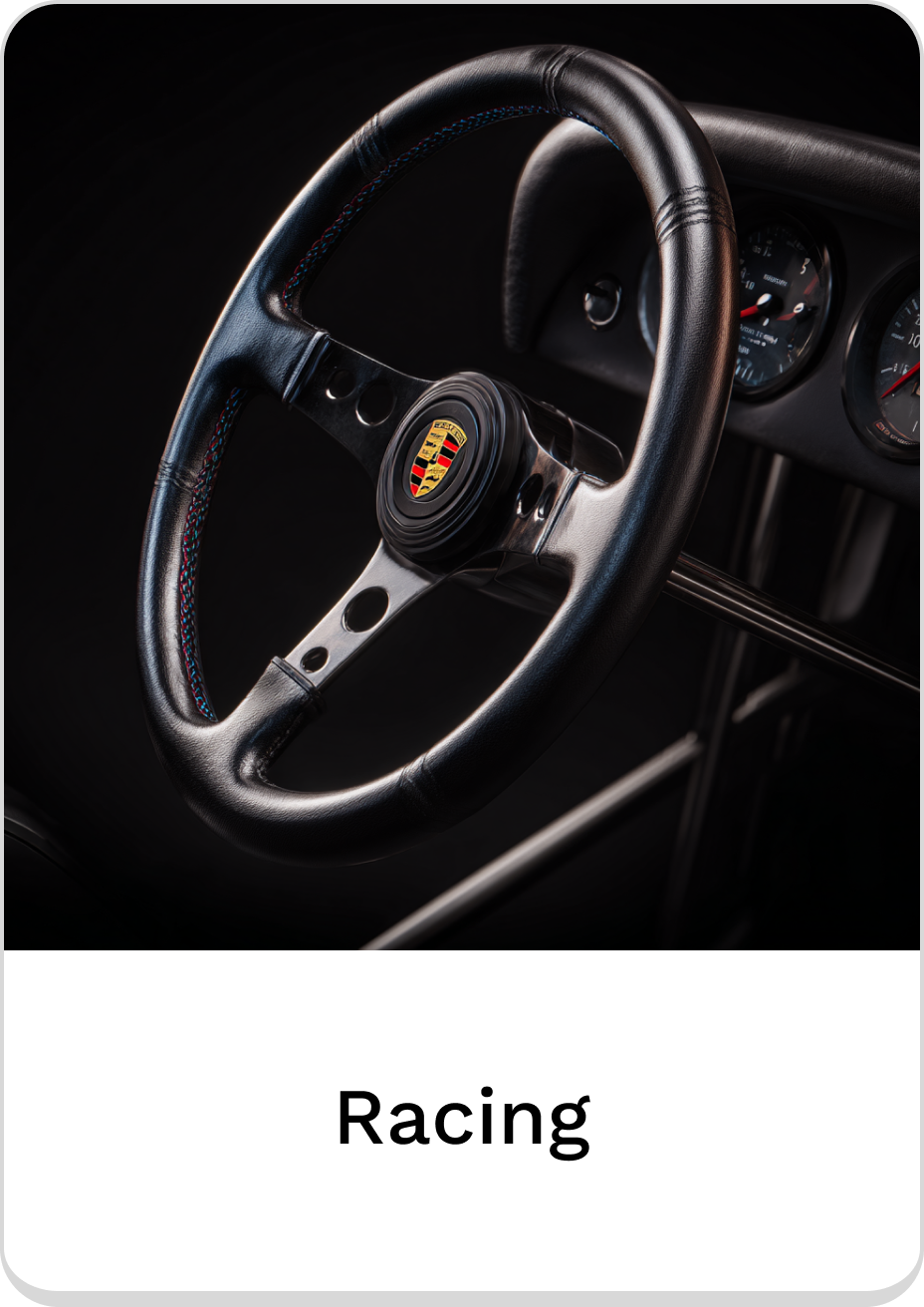 Stylish racing steering wheel with black leather and iconic logo.