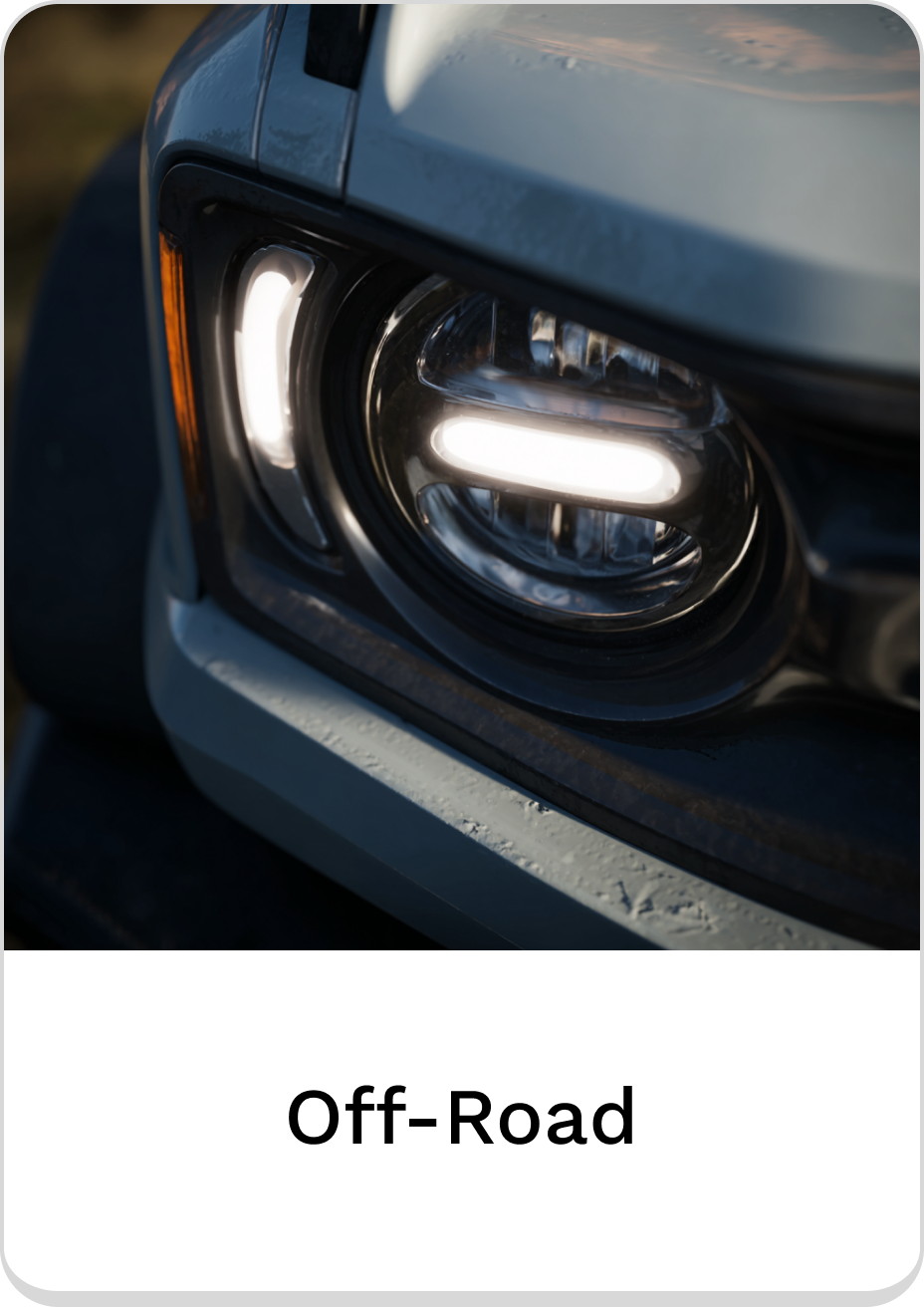 Close-up of off-road vehicle headlights with sleek design and bright illumination.