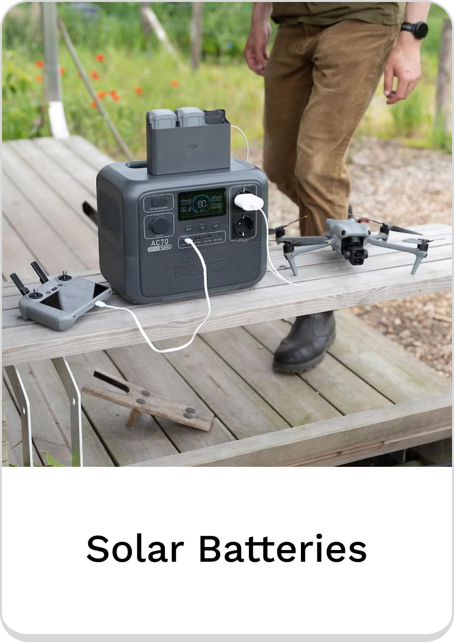 Portable solar batteries charging device on a wooden table outdoors.