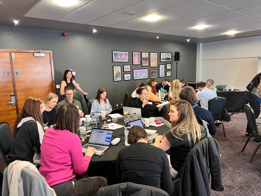 Dr Alexandra - Collaborative Workshop Session with Professionals in a Conference Room
