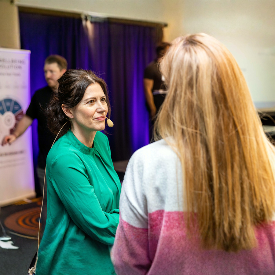 Dr Alexandra Smiljanic - Speaker Engaging with Attendee at Wellbeing Workshop