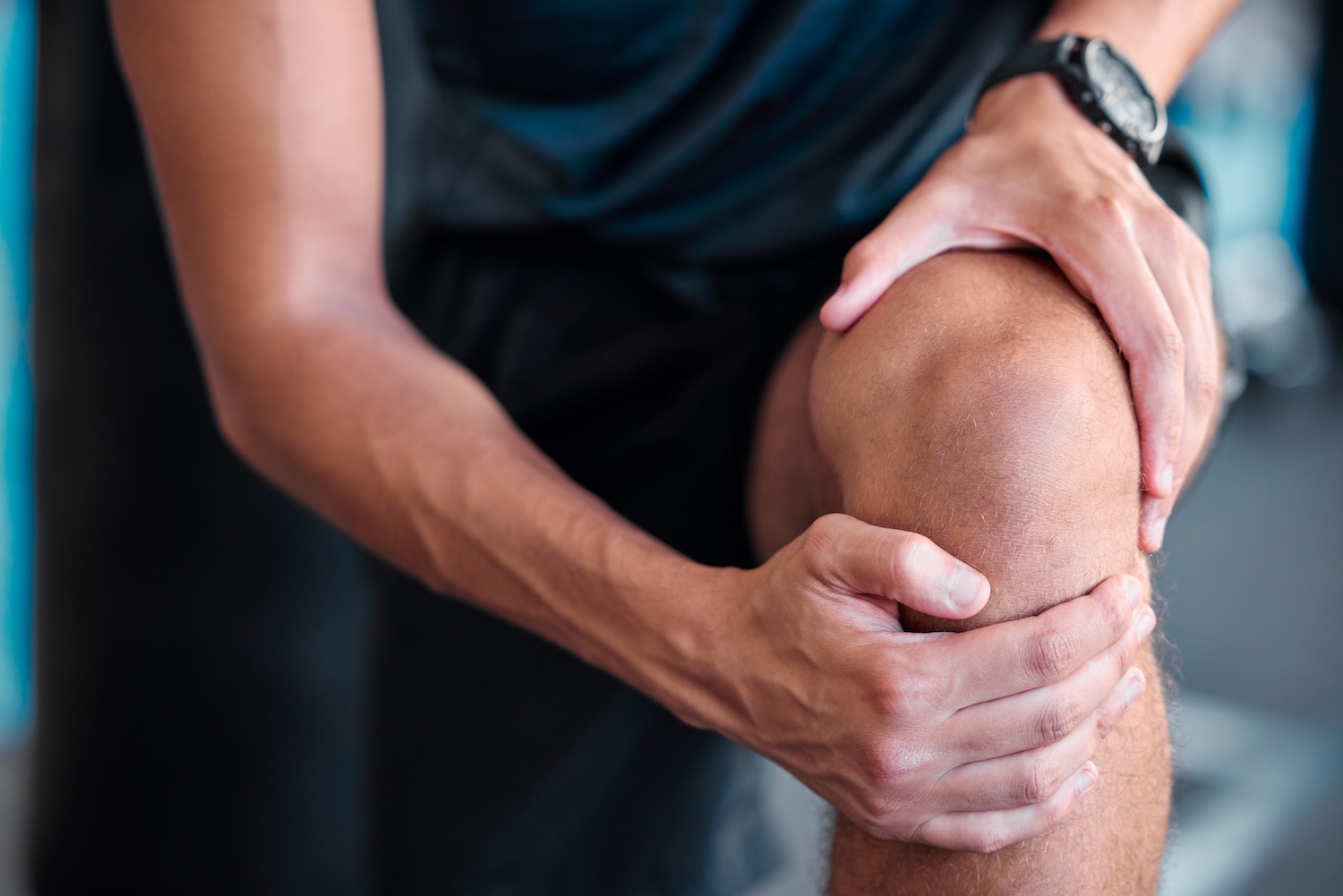 Mann hält sein Knie
