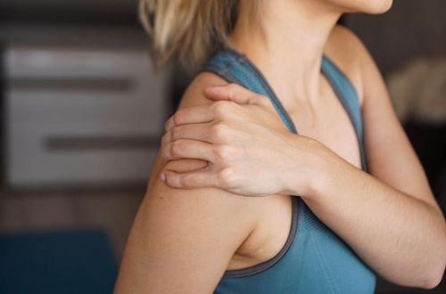 Physiotherapist treating a trigger point in a patient's shoulder and neck area