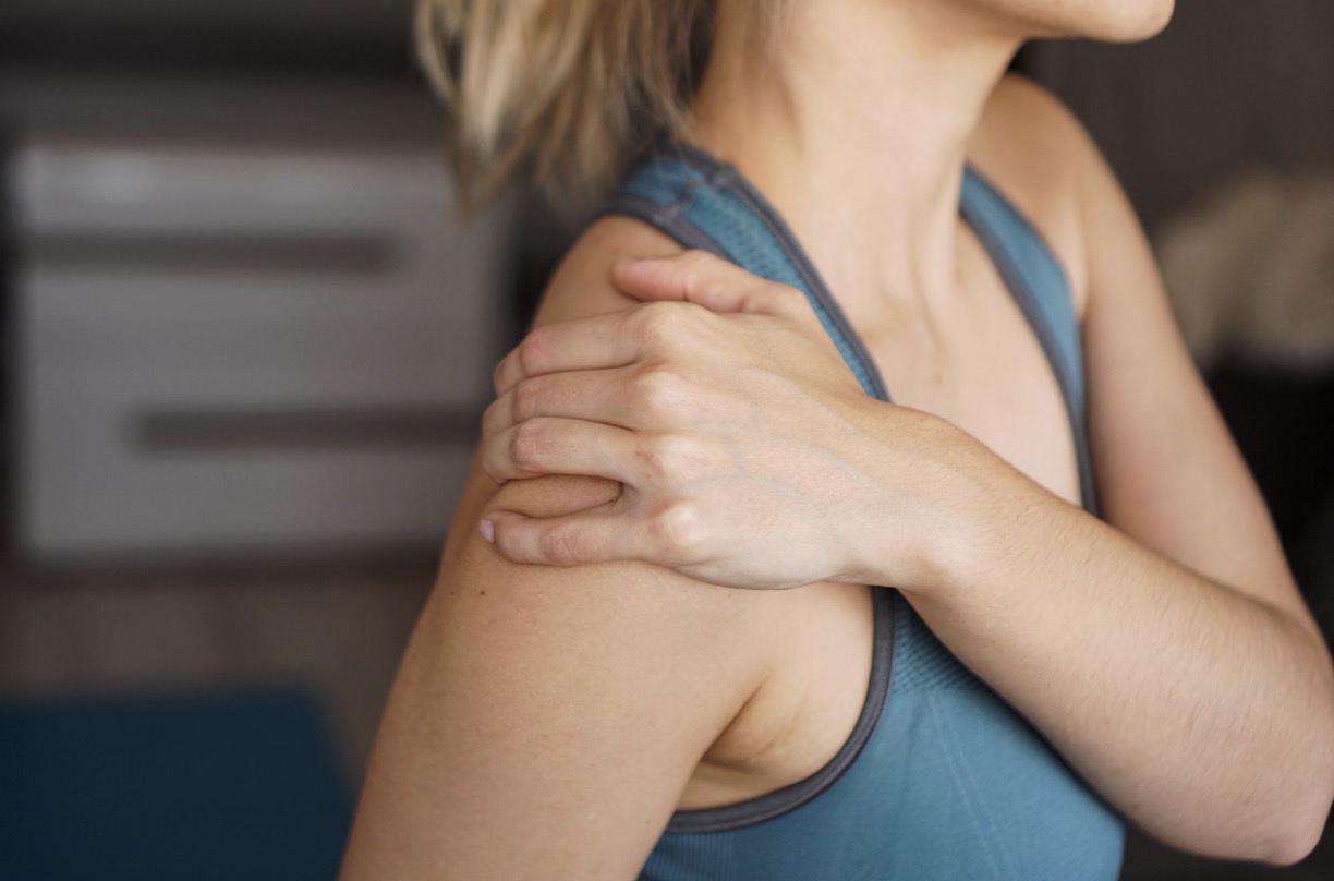Physiotherapist treating a trigger point in a patient's shoulder and neck area