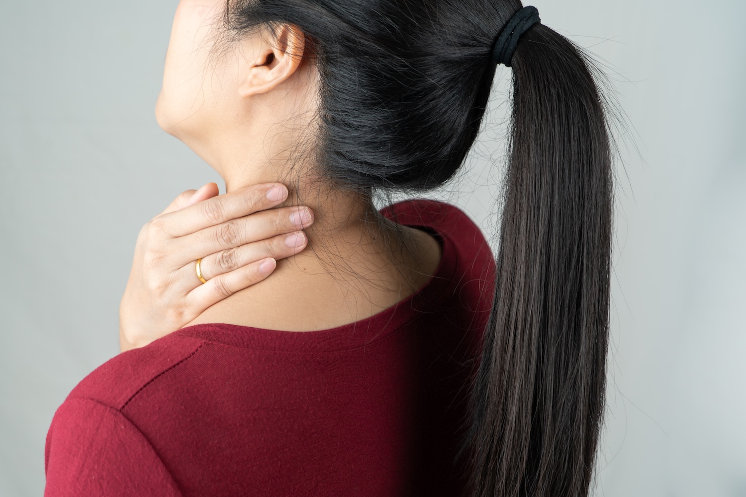 Physiotherapist treating a trigger point in a patient's shoulder and neck area