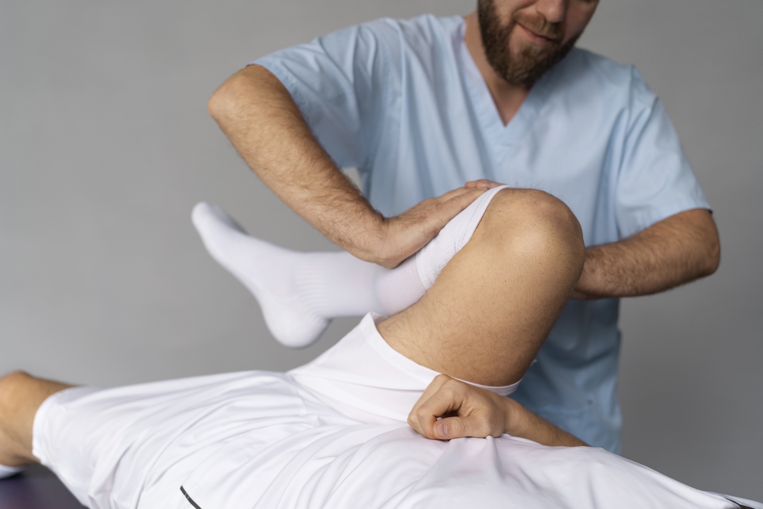 a physiotherapist treats a patient's knee