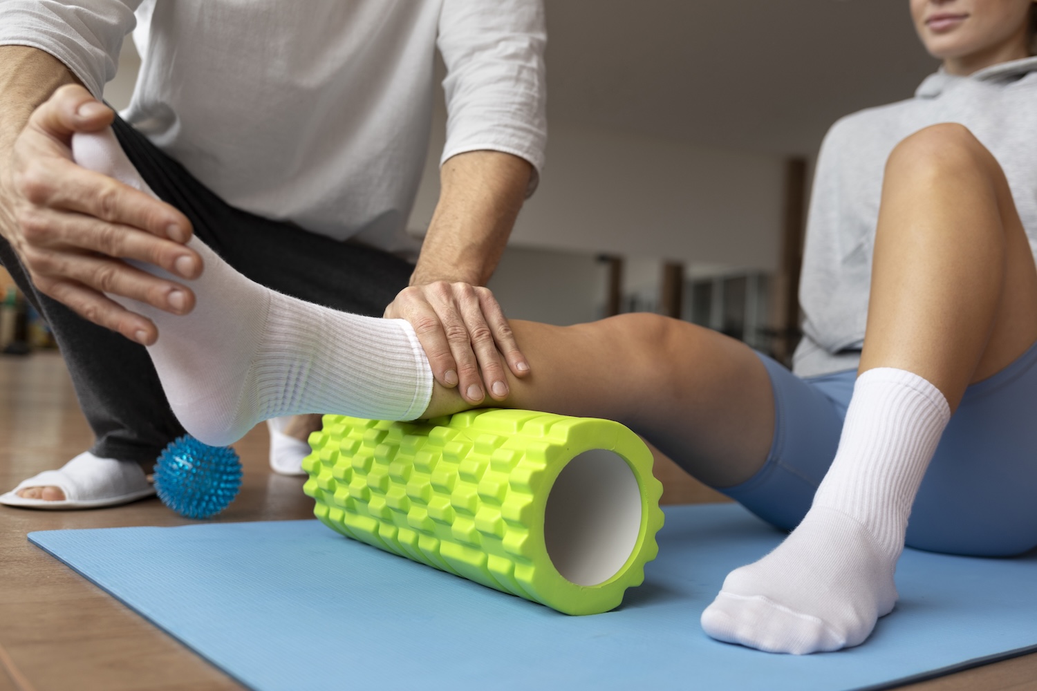 a woman is treated in physiotherapy for her knee problems