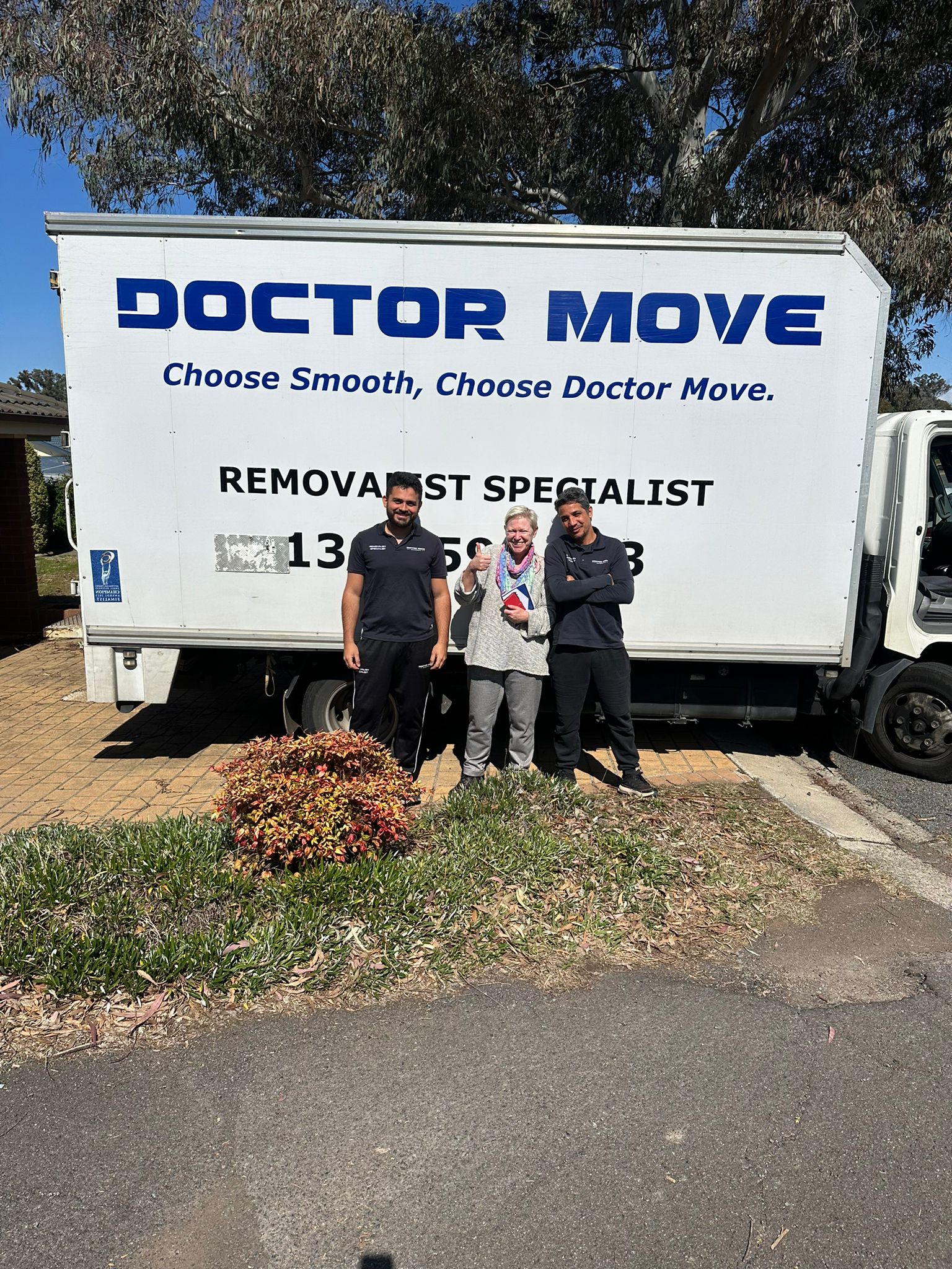 Doctor Move Canberra removalist team with client in front of doctor move truck