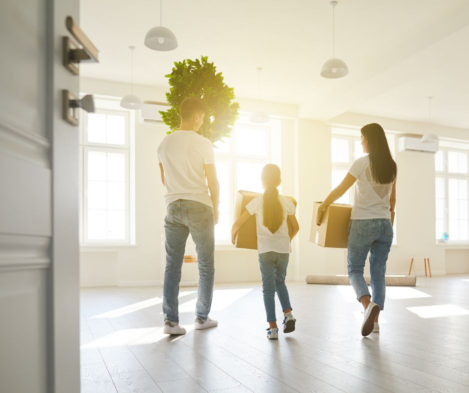 Family moving boxes in empty house. Moving Company has helped the family with moving.