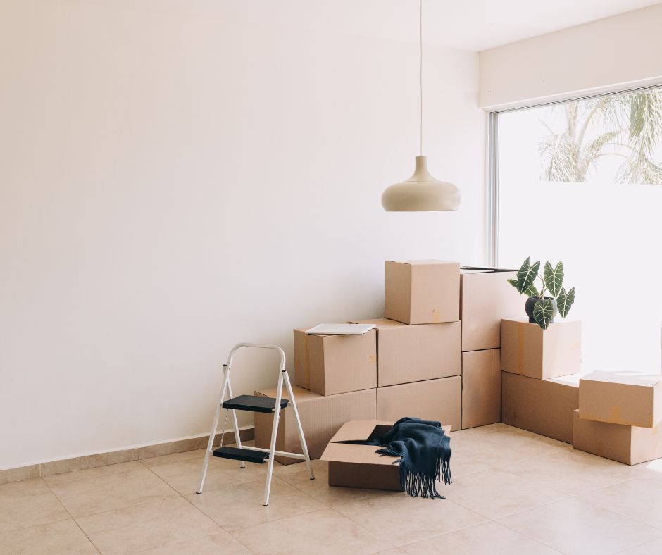 stack of boxes in the corner of empty space ready for movers in canberra to  move to a different location in canberra