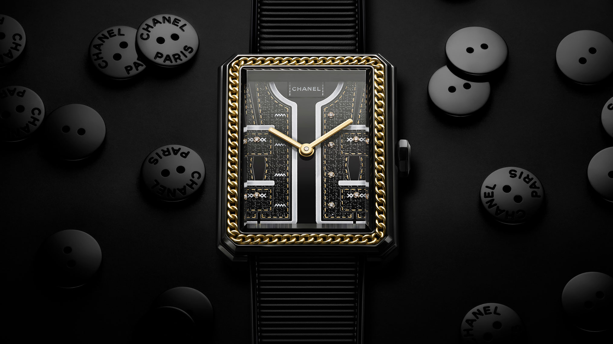 Focus on the dial of the Chanel Boy Friend Watch, sewing buttons placed on the black background, Couture Collection, 2024