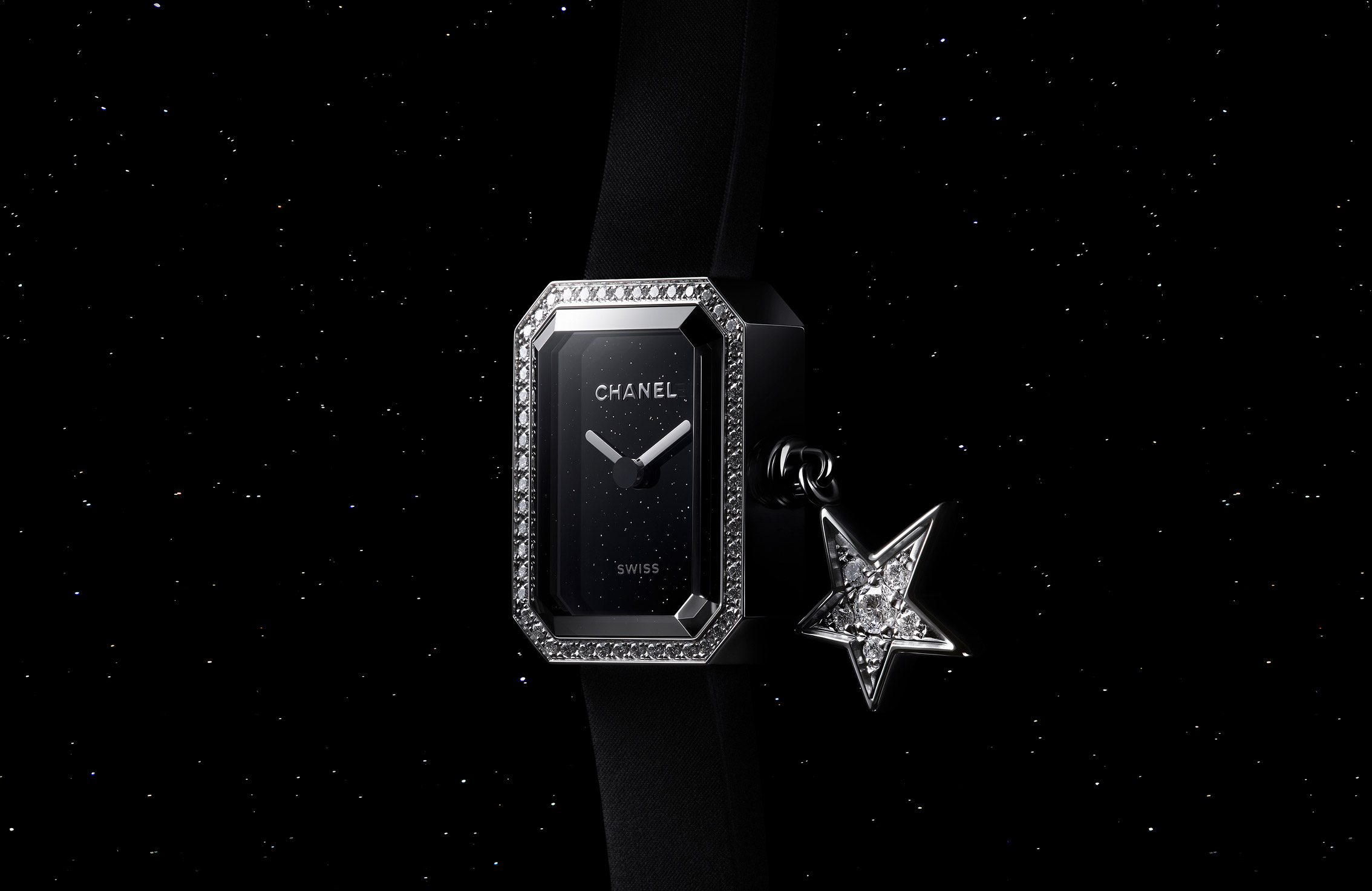 Focus on the dial of the Chanel Première Watch and its star charm, against a galactic background of a starry sky, Interstellar Collection, 2023