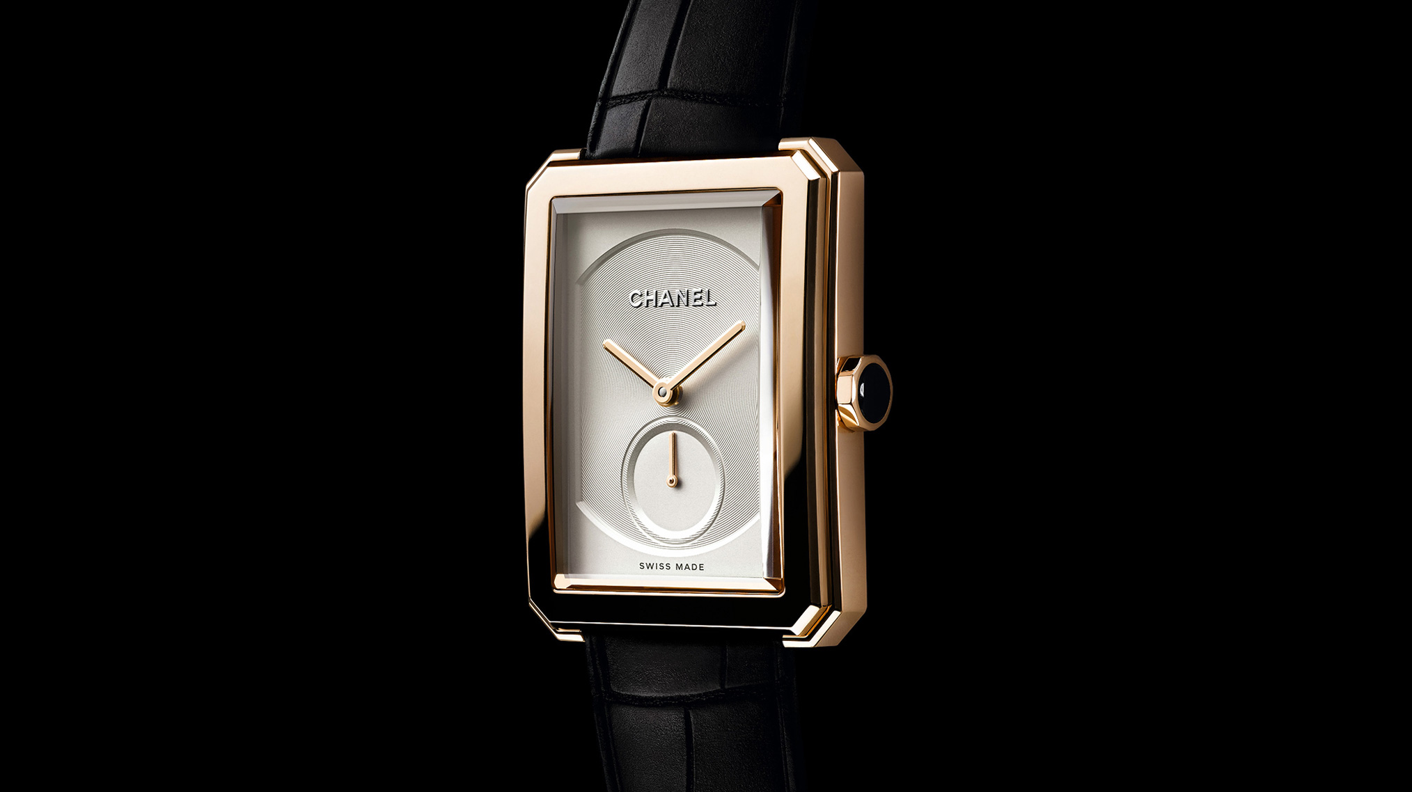 Focus on the dial of the Chanel Boy Friend Watch, aligator bracelet, black background