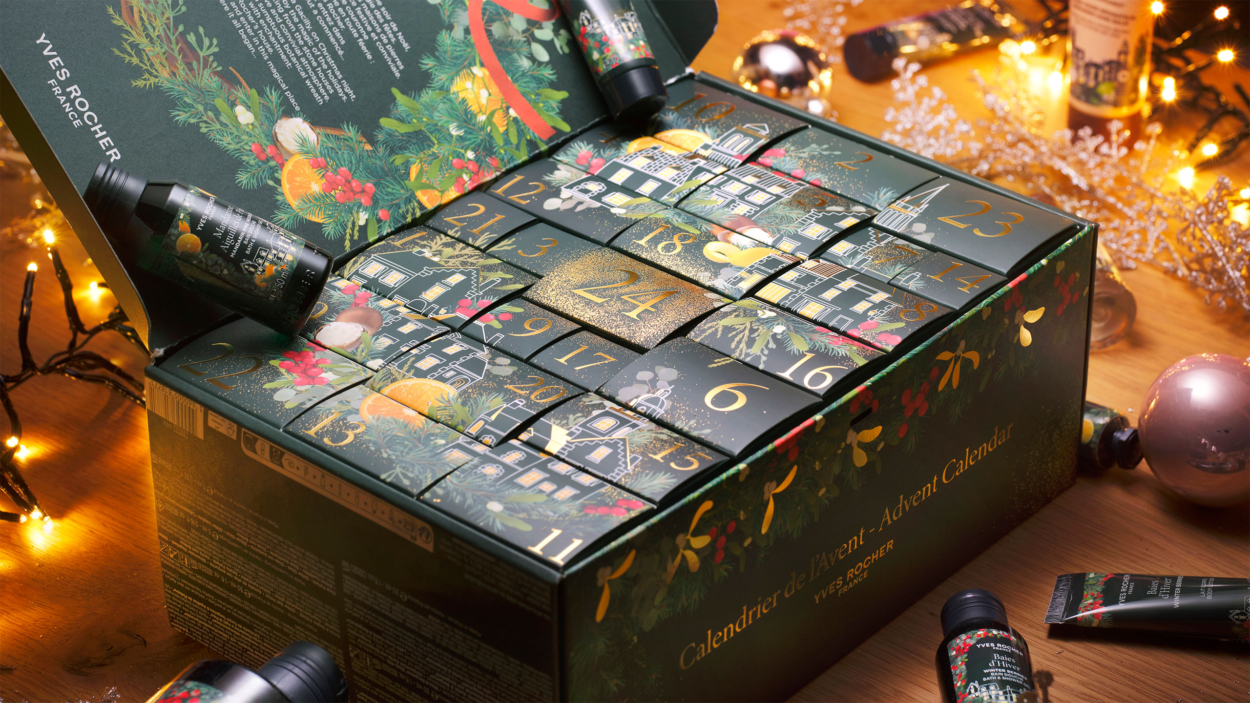 Top view of the fully opened Yves Rocher 2025 Advent Calendar displaying all numbered drawers and compartments, surrounded by selected beauty products and festive decor.