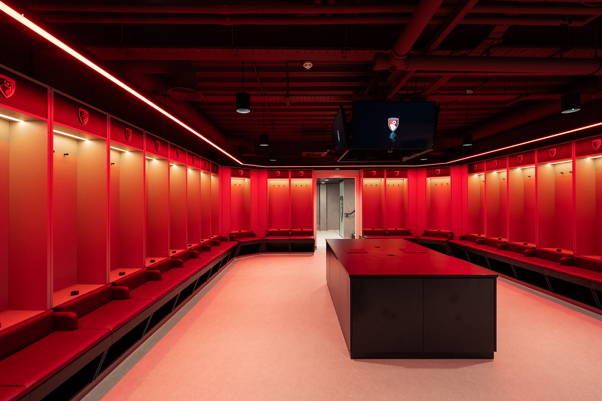 A directors lounge at Ipswich stadium with views to the pitch, showcasing interior design, furniture and bar