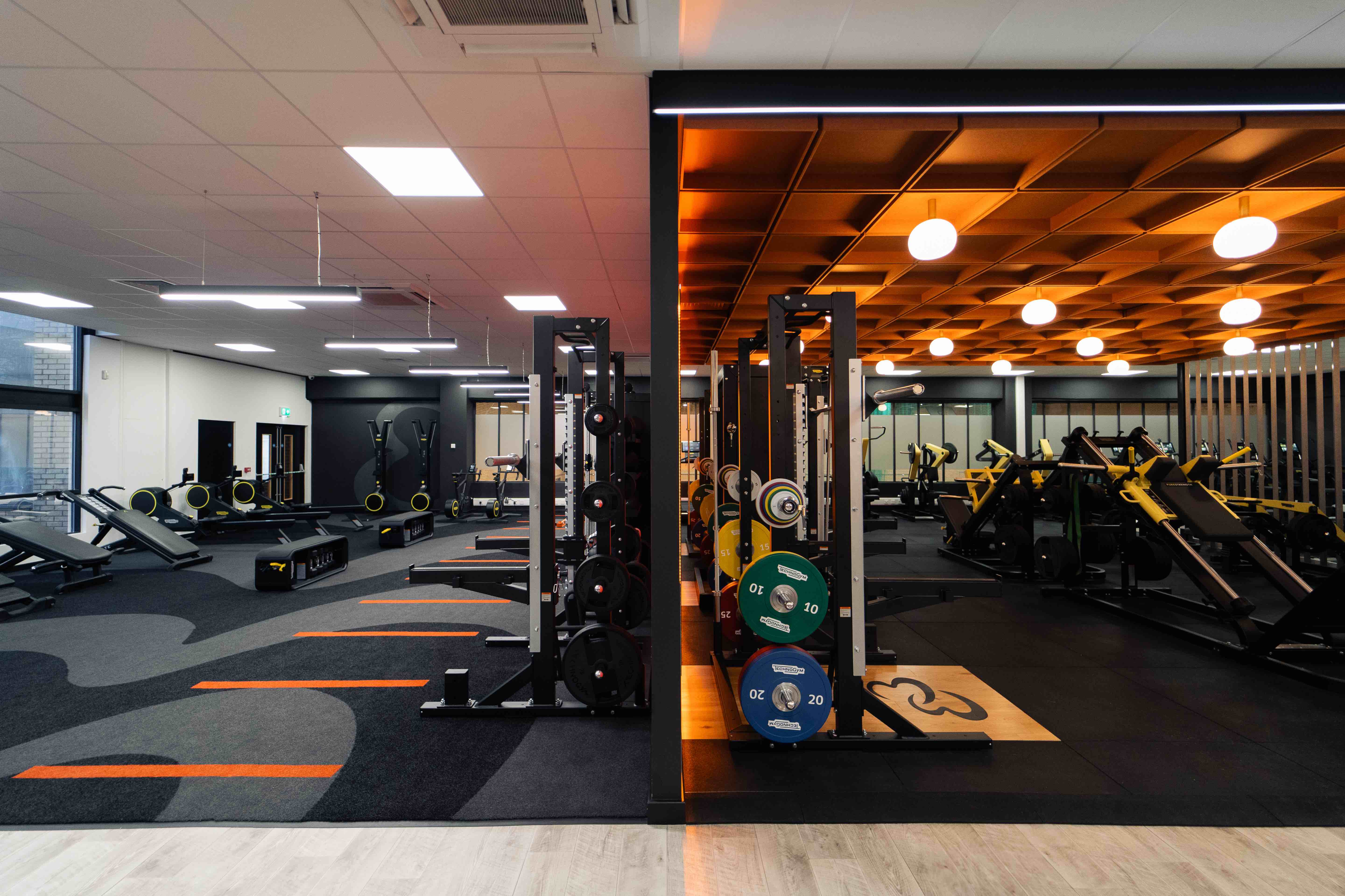 A directors lounge at Ipswich stadium with views to the pitch, showcasing interior design, furniture and bar