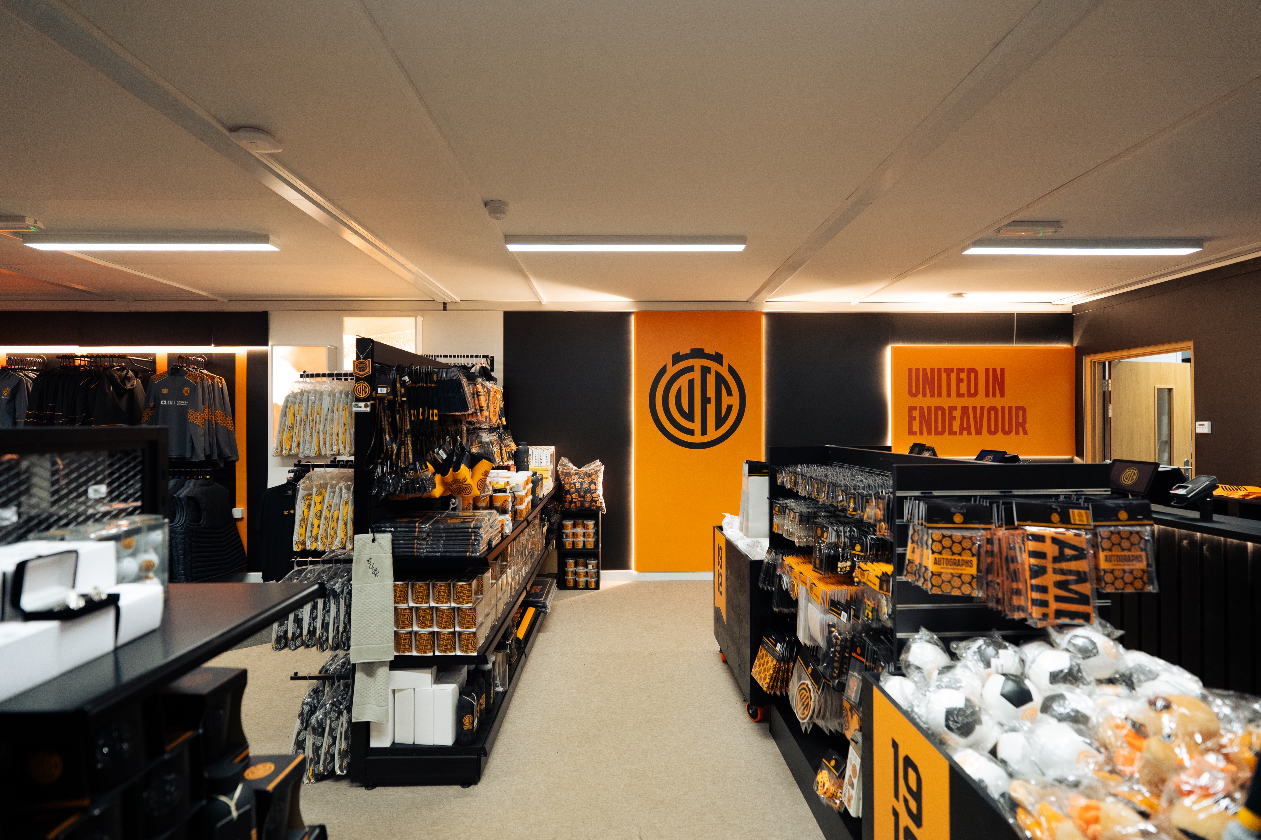 A directors lounge at Ipswich stadium with views to the pitch, showcasing interior design, furniture and bar