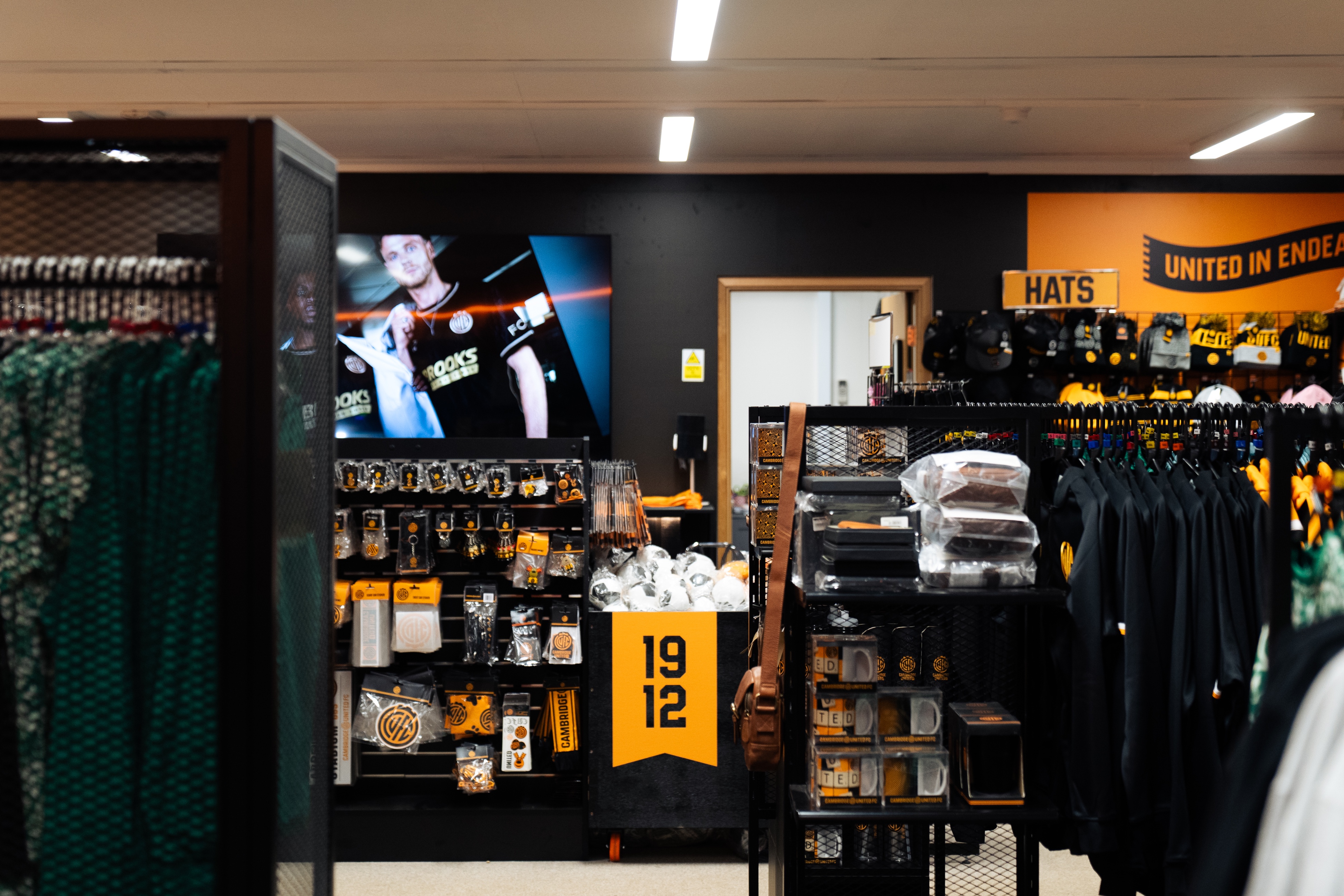 football retail store with a range of orange and black football merchandise on the wall