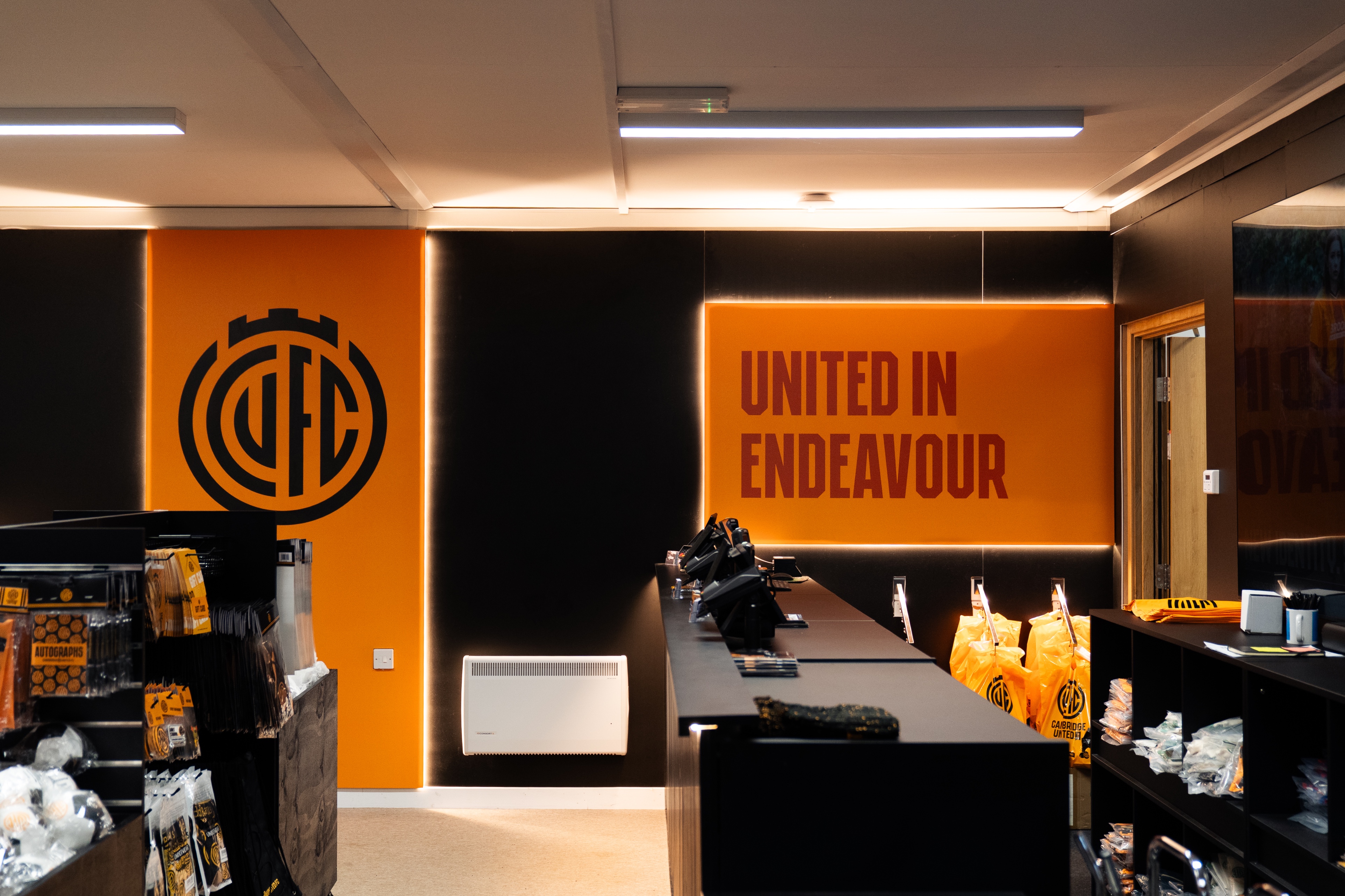 orange and black football logo displayed on the wall of a football retail store