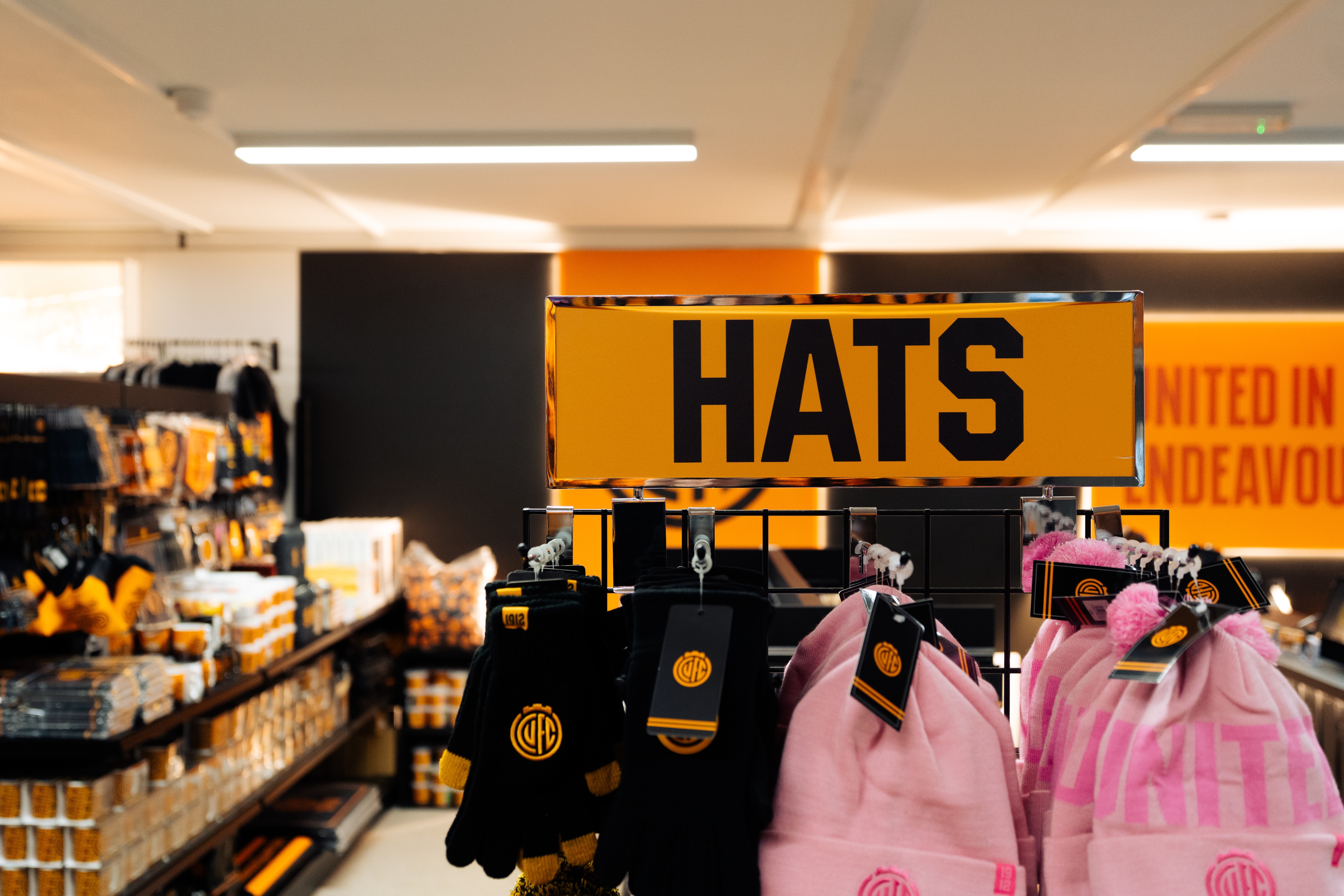 close up of merchandise stand featuring hats