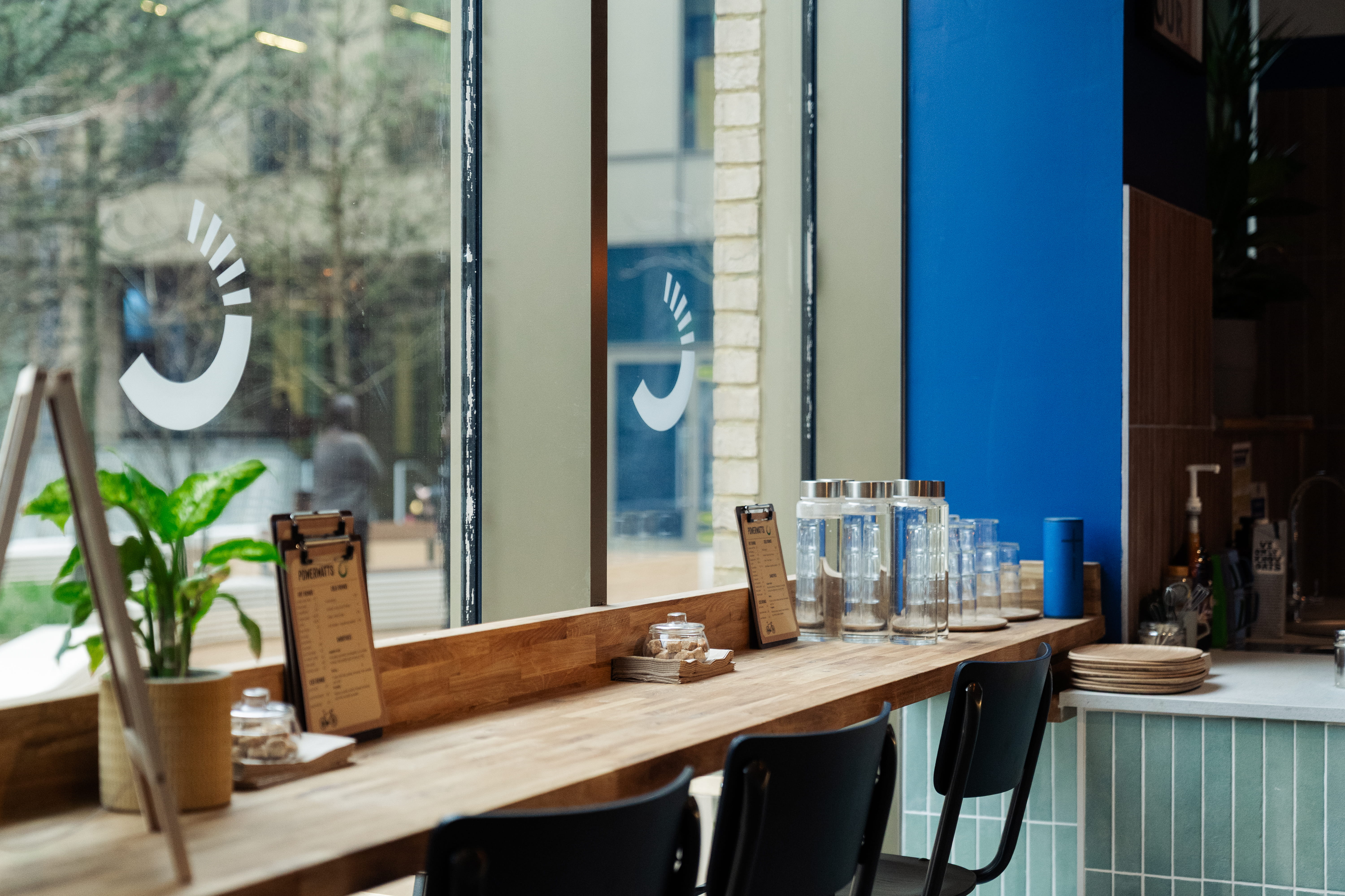 wooden bench table with black seats looking out of a window