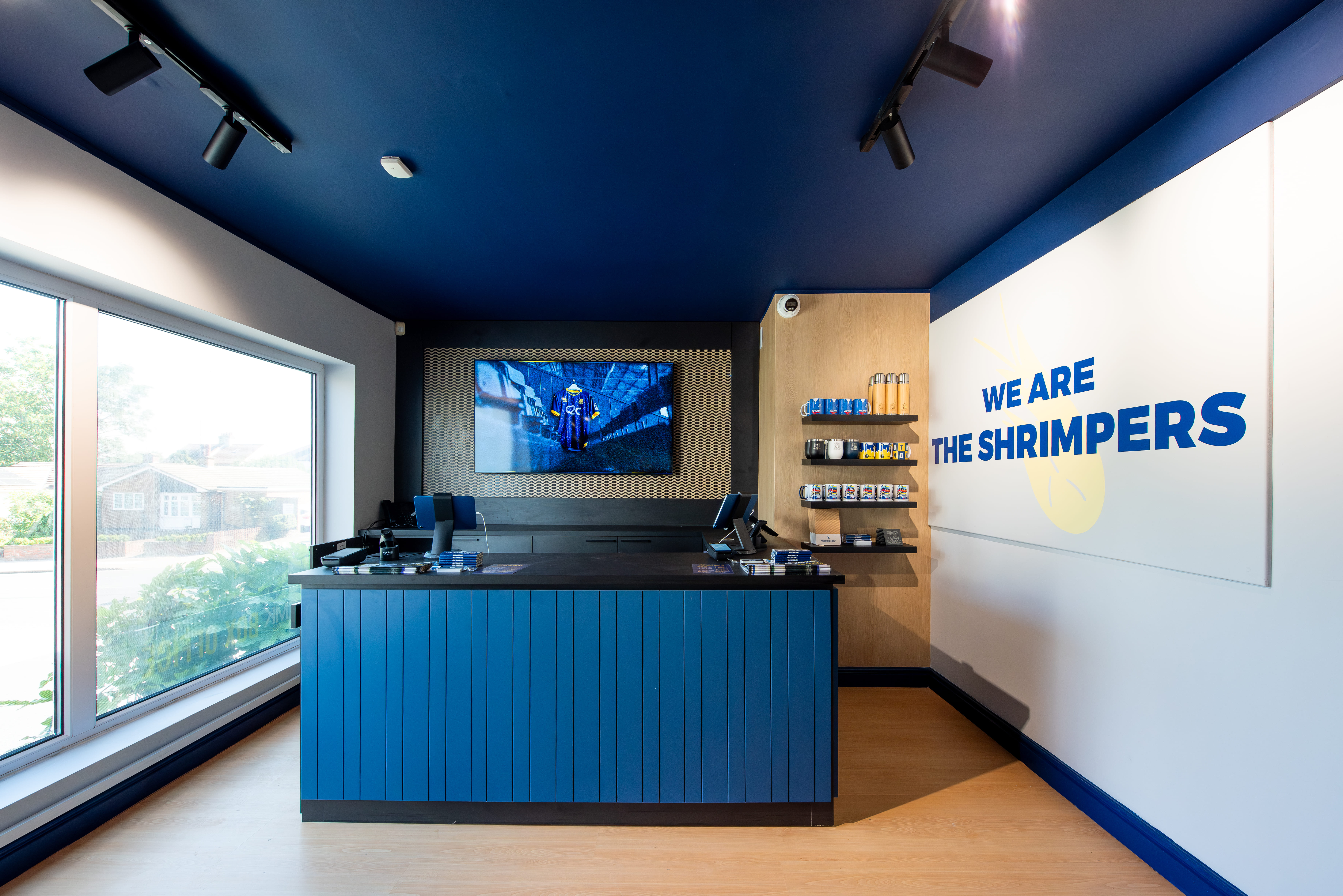 A directors lounge at Ipswich stadium with views to the pitch, showcasing interior design, furniture and bar