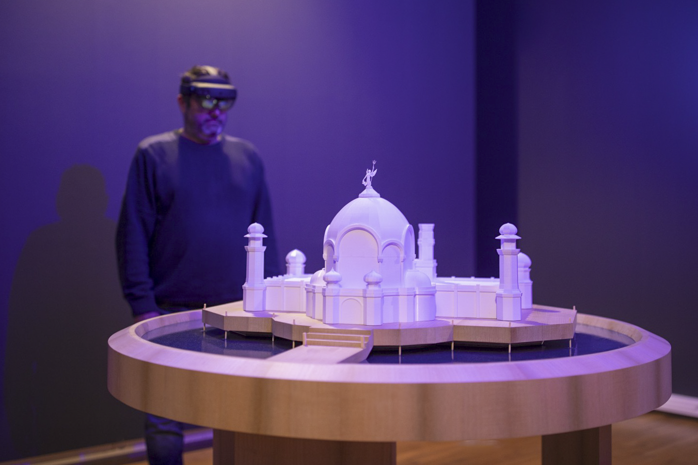 Mixed reality experience with HoloLens, visitor observing an augmented heritage model, interactive museum immersion, holographic technology for cultural mediation