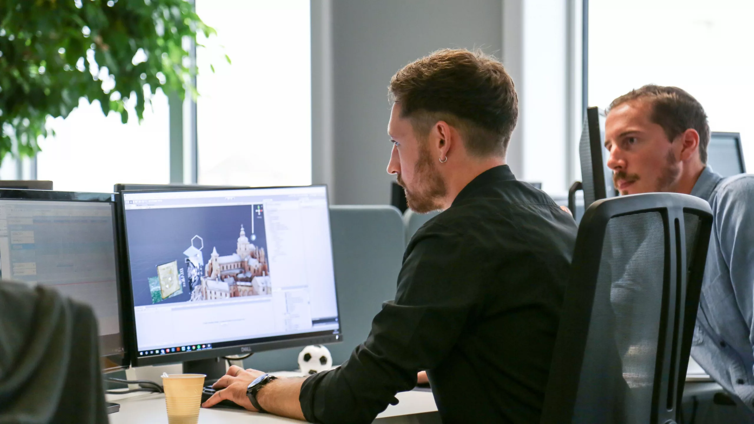 Developers working on the 3D modeling and design of the Mont Saint-Michel mixed reality experience in the offices of HoloForge Interactive.