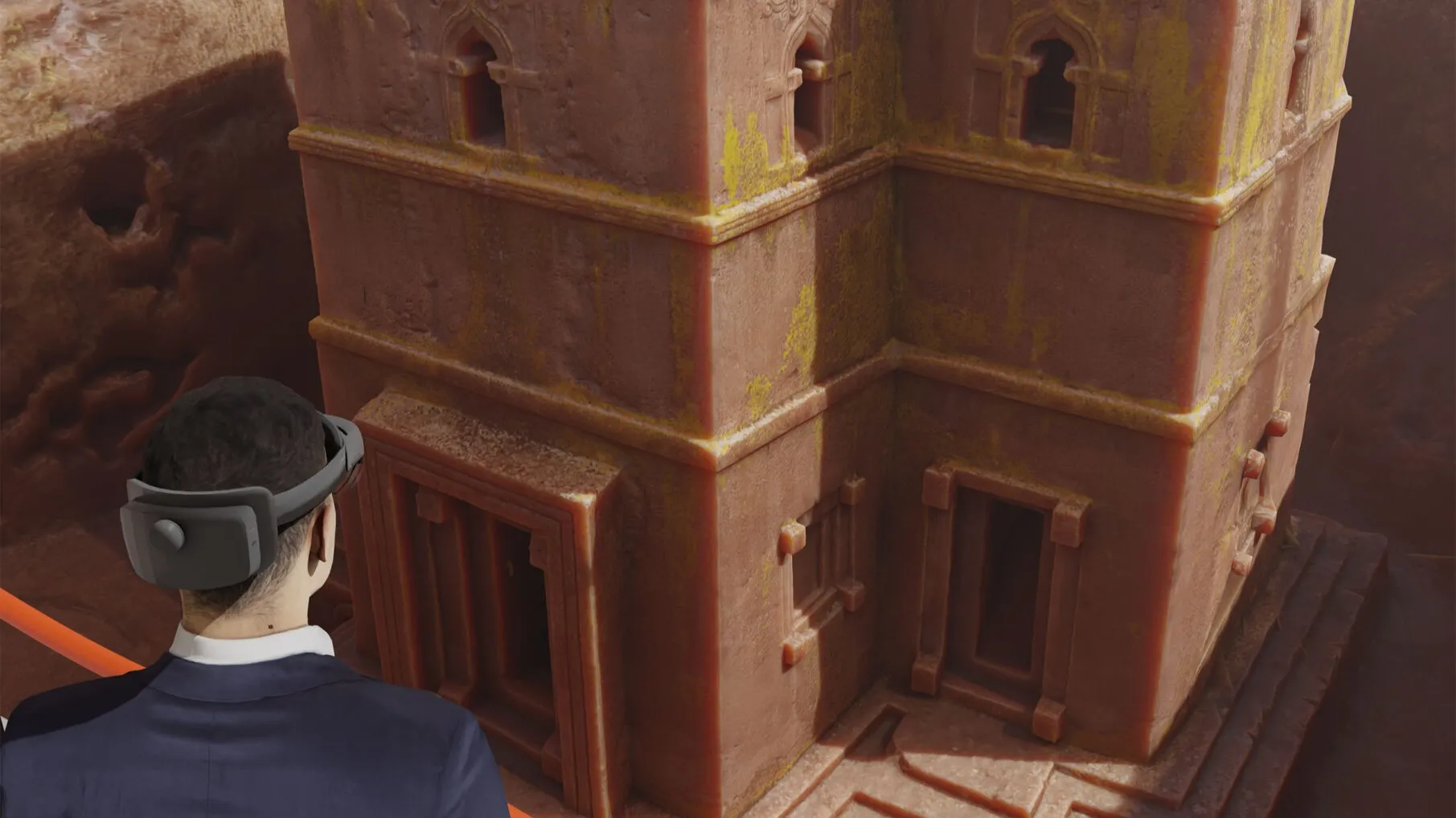 Man in a mixed reality headset watching a 3D reconstruction of the monolithic Saint George's Church (Bete Giyorgis) in Lalibela, Ethiopia
