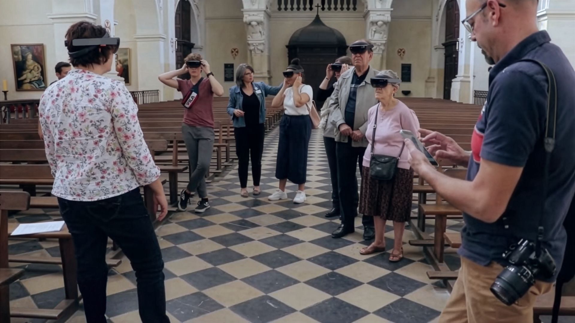Group of visitors wearing HoloLens headsets during an immersive visit to the Saint-Louis Church of the Prytanée National Militaire, discovering the heritage of the Loir Valley through mixed reality.