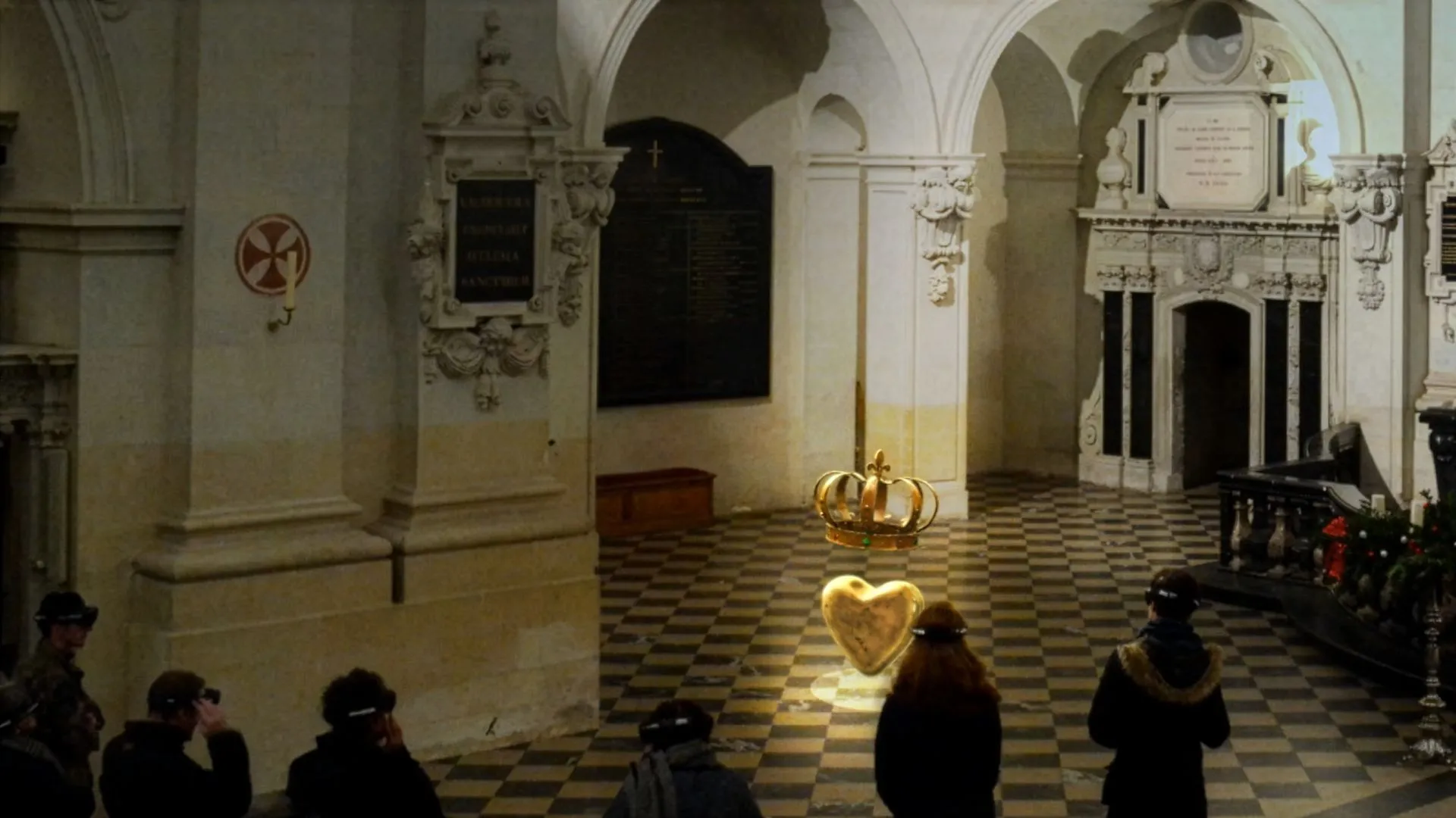 Visitors equipped with HoloLens headsets observing a mixed reality reconstruction of the king's heart and crown inside the Saint-Louis Church of the Prytanée National Militaire, during an immersive experience to promote heritage.