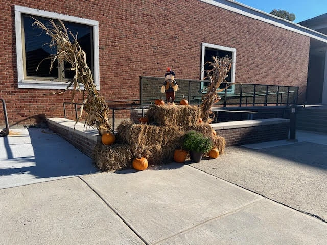 Seasonal fall decorations integrated into landscaping design