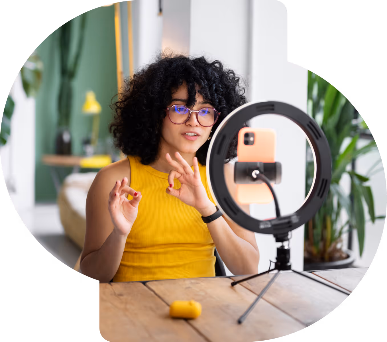 Woman filming TikTok with ring light set up